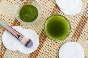 Matcha powder and liquid with makeup brush and cotton rounds