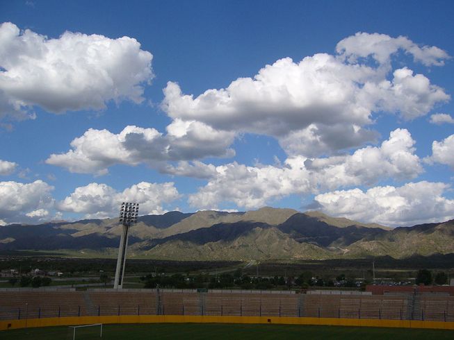 Cumulus mediocris clouds over a sports field