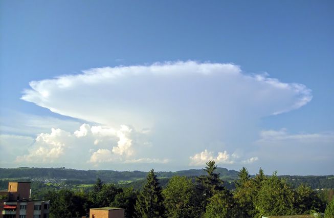 A large cumulonimbus cloud with an incus top