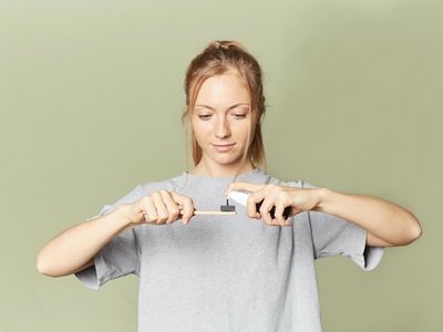 putting dental gel on brush