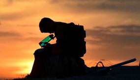 A child looks at his water bottle as the sun sets on June 15, 2021 in Los Angeles, California as temperatures soar in an early-season heatwave. 