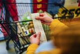 Woman checking the bill when paying at a supermarket