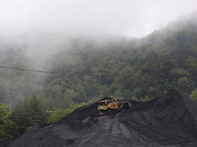 A bulldozer operates atop a coal mound at the CCI Energy Slones Branch Terminal June 3, 2014 in Shelbiana, Kentucky. 