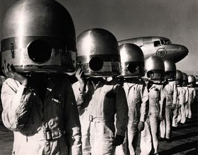 1941 photo showing plane mechanics and the future of plane travel with TWA plane