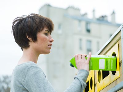 Woman recycling milk carton
