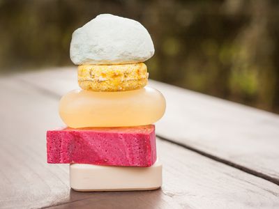 Stack of package-free soaps and a shampoo bar