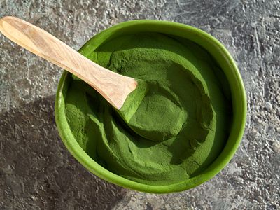 Green chlorella algae powder in a bowl