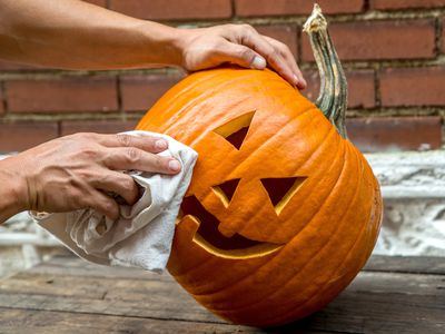 tilted pumpkin gets cleaned with rag