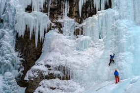 Ice climber on the frozen Upper Falls of the Johnston Creek
