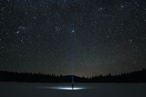 man looking up at night sky