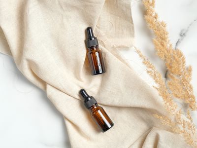 Glass amber jars full of oil for healthy skin.