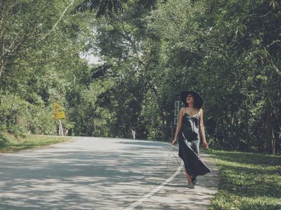 woman walking along road