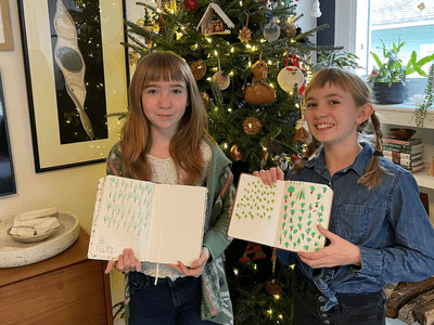 Sami Grover's two daughters holding journals